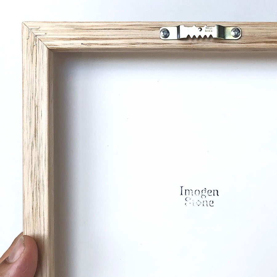 back of Tasmanian oak frame showing saw-tooth hanger and Imogen Stone stamp