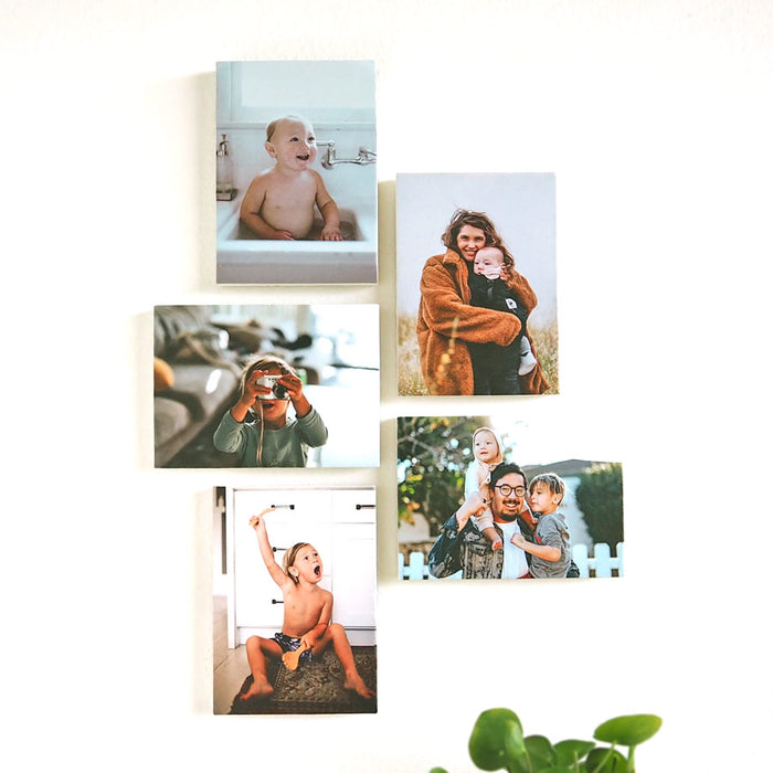 Stone tiles featuring family photos, displayed on a wall – handcrafted by Imogen Stone
