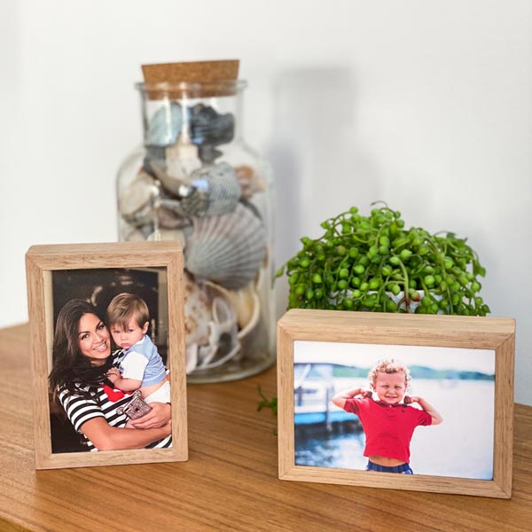 Portrait and landscape desktop stone photo prints displayed together, framed in native Australian Tasmanian Oak, featuring family photos